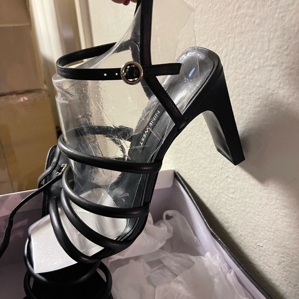 Black leather strappy heels. Never worn.